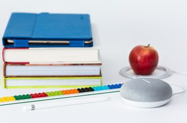 honeycrisp apple fruit near books and chalk Google Home Mini smart speaker