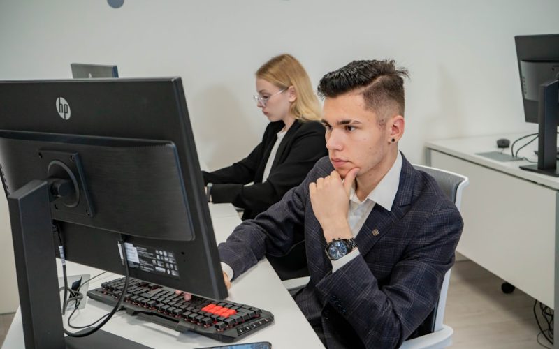 a man sitting at a desk in front of a computer