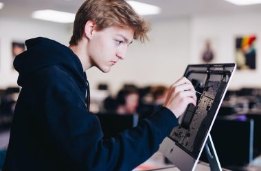 a young man working on a laptop computer