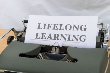 a close up of a typewriter with a sign on it