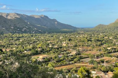 a scenic view of a small town in the mountains
