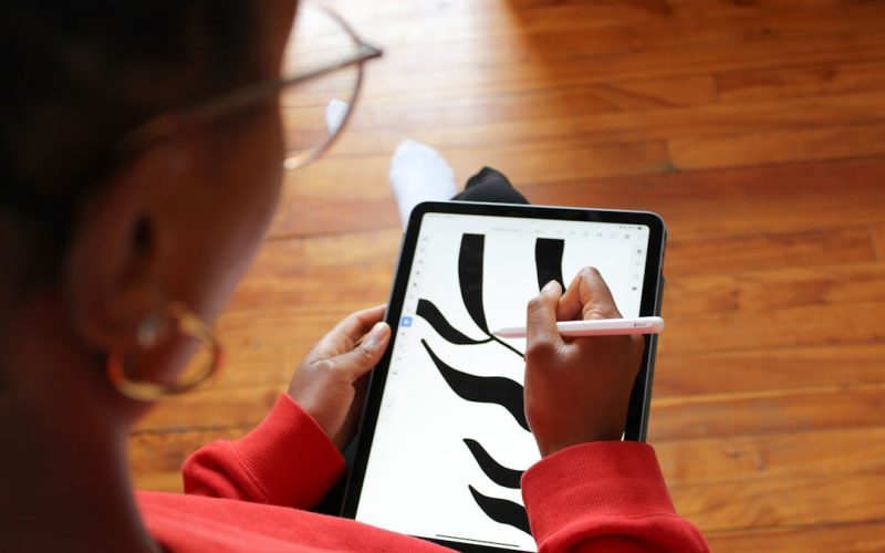 a woman is using a tablet with a zebra pattern on it
