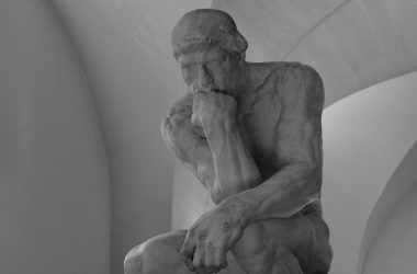 a black and white photo of a statue of a man