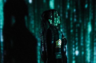 a woman with long hair standing in a dark room