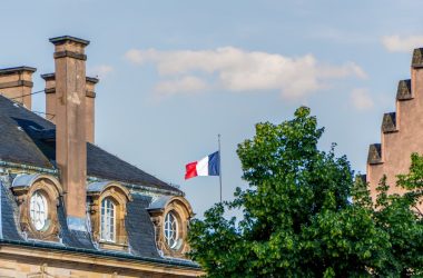 A tall building with a flag on top of it