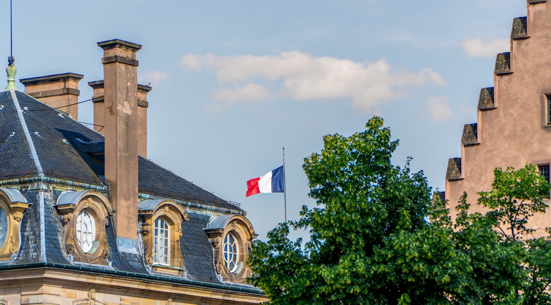A tall building with a flag on top of it