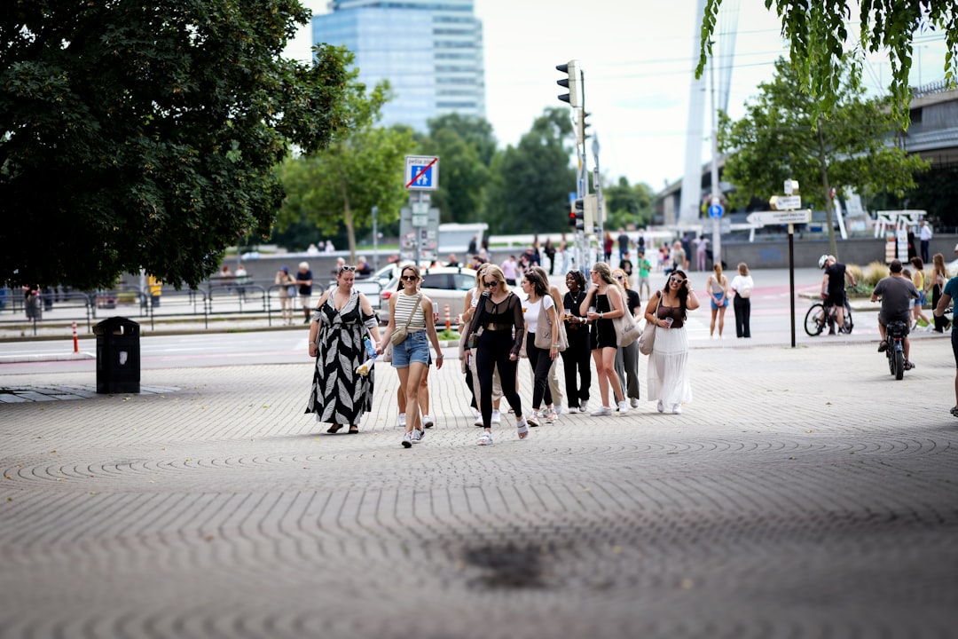 A group of people walk on a paved road.