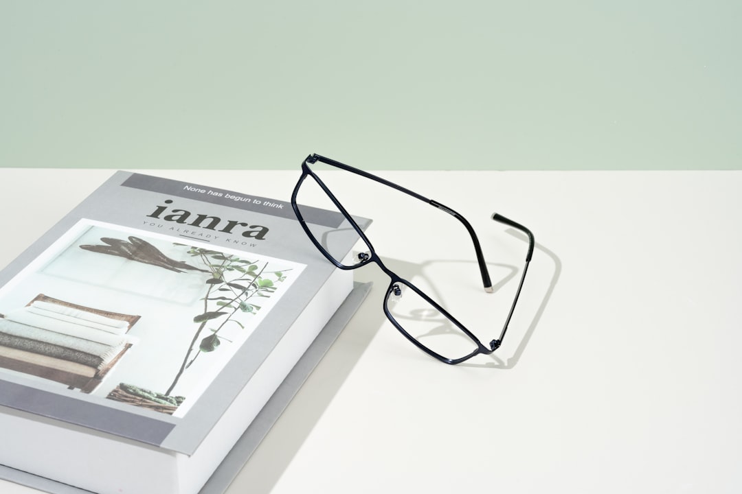 A pair of glasses sitting on top of a book