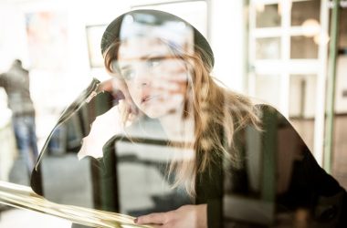 photo of woman leaning on brown table