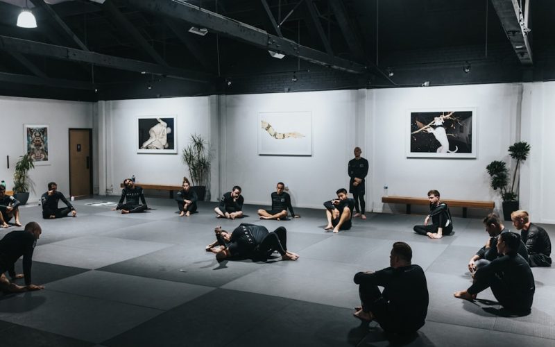 people sitting on floor in front of white wall