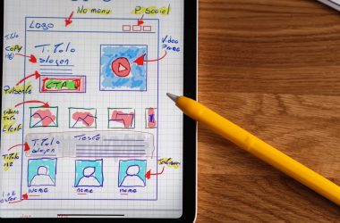 a tablet with a drawing on it next to a pencil
