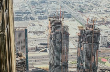 a couple of tall buildings sitting next to each other