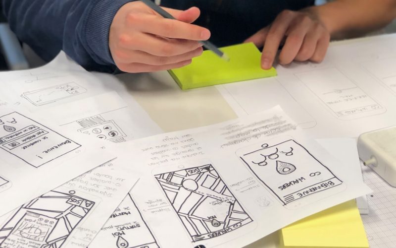 person writing on white paper
