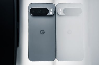Two cell phones sitting next to each other