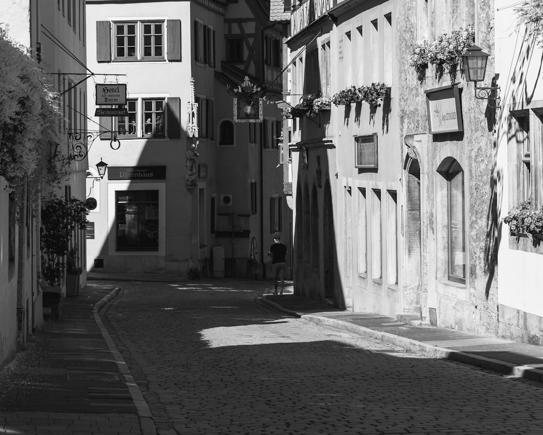 A black and white photo of a narrow street