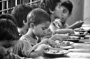 boy and girl eating on table