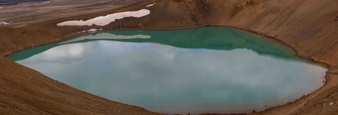 a large body of water surrounded by brown hills