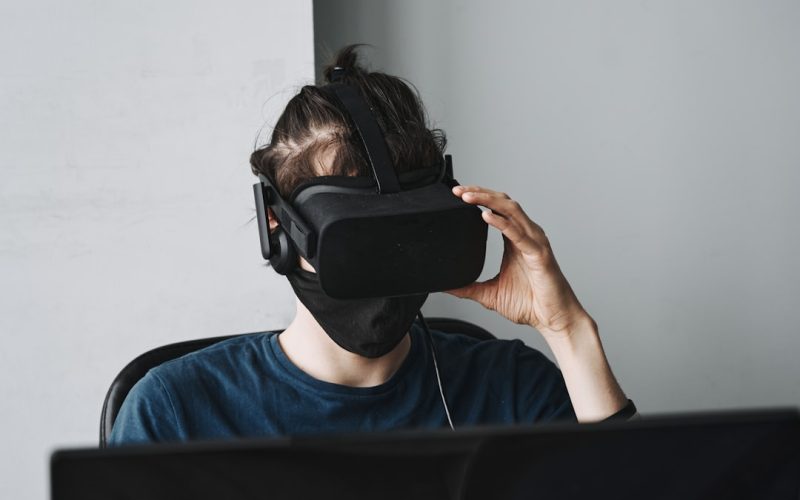 man in blue crew neck shirt wearing black vr goggles