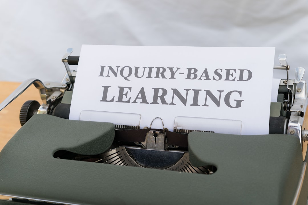 a close up of a typewriter with an inquiry - based learning sign