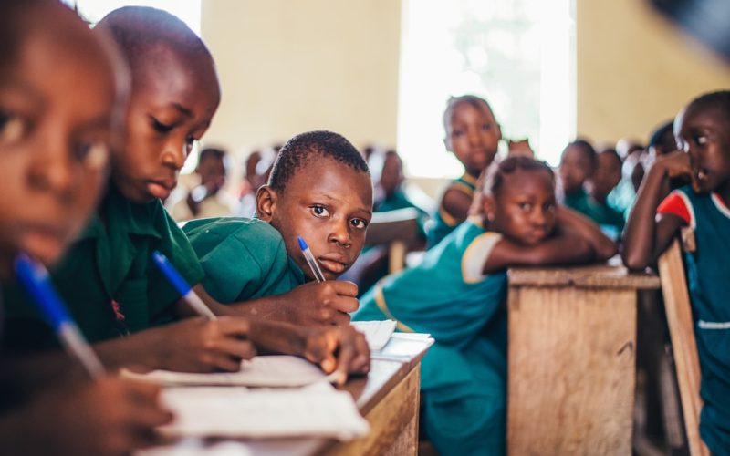 children writing in books