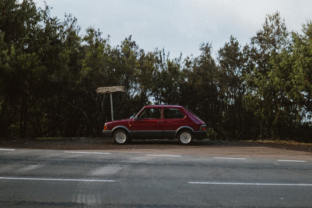 a red car parked on the side of the road