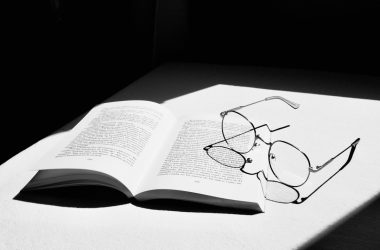 white book page with black earbuds