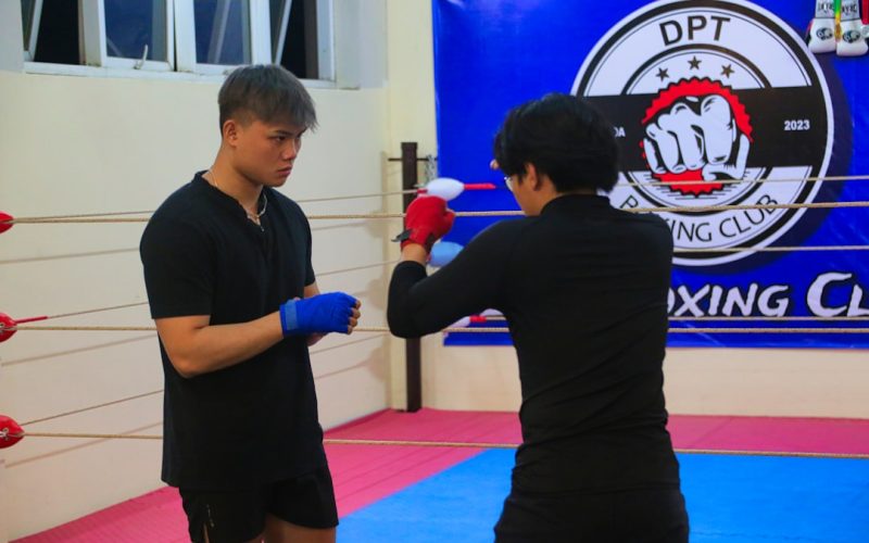 a man and a woman standing in a boxing ring