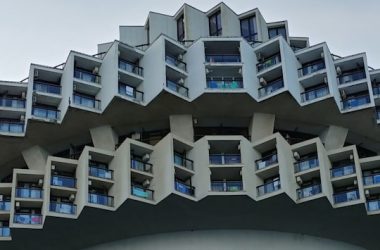 a very tall building with many windows and balconies
