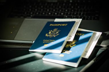 a passport sitting on top of a computer keyboard