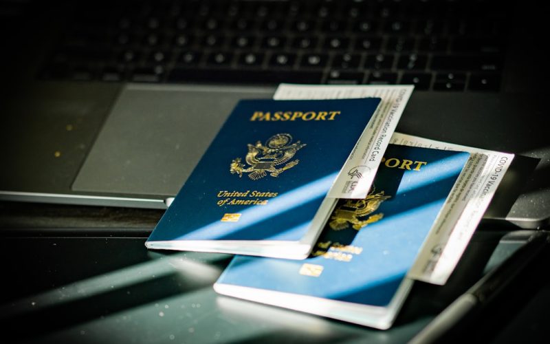 a passport sitting on top of a computer keyboard