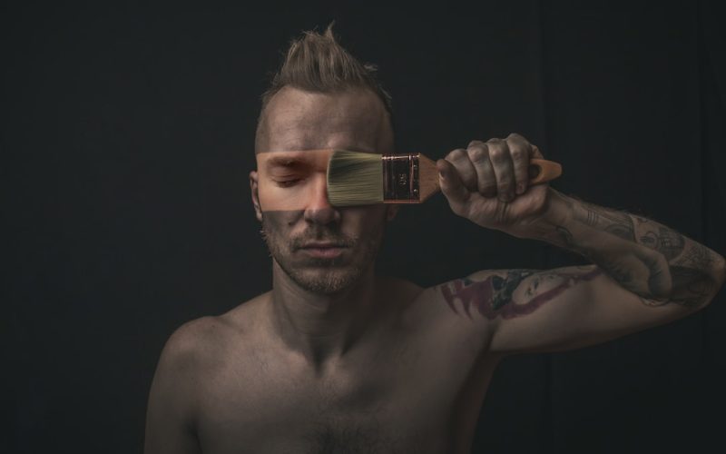 man holding paintbrush