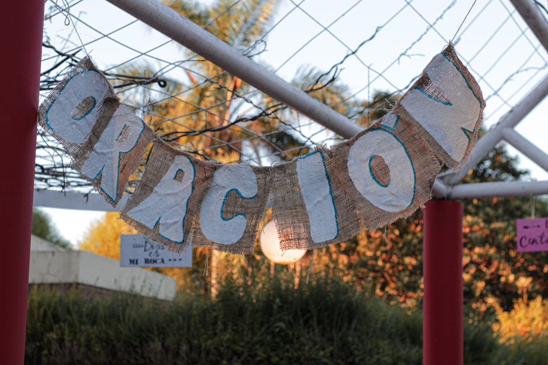 a sign that says welcome hanging from a fence