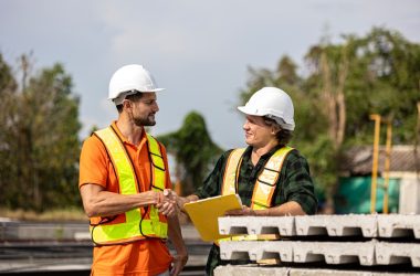 Construction workers shake hands after a deal.