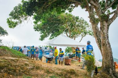 a group of people standing around a white tent