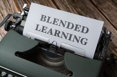 a close up of a typewriter with a sign that reads blended learning