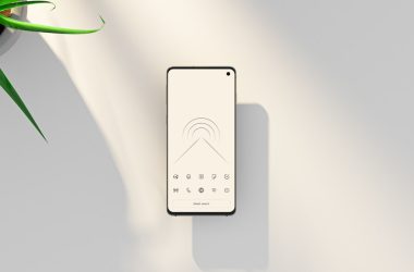 a cell phone sitting on top of a table next to a plant