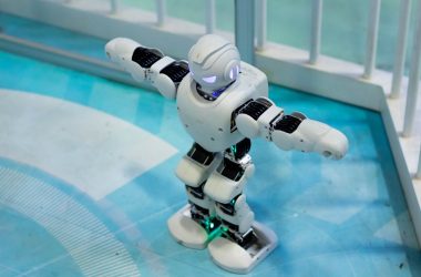 a toy robot standing on a blue floor