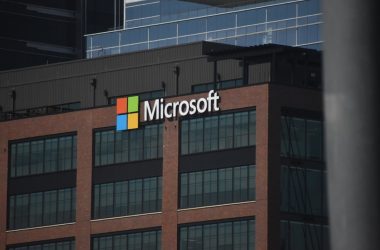 A tall building with a microsoft logo on top of it