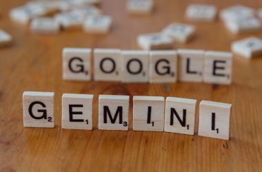 A wooden table topped with scrabble tiles spelling google, genni, and