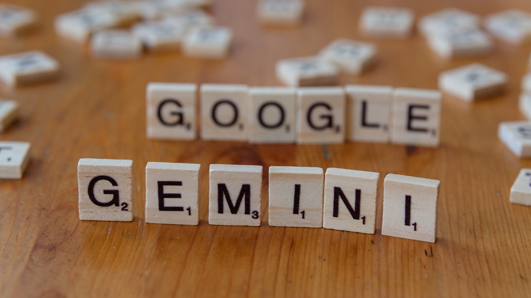 A wooden table topped with scrabble tiles spelling google, genni, and