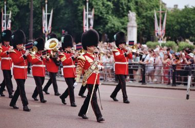 A british band is marching in a colorful parade.