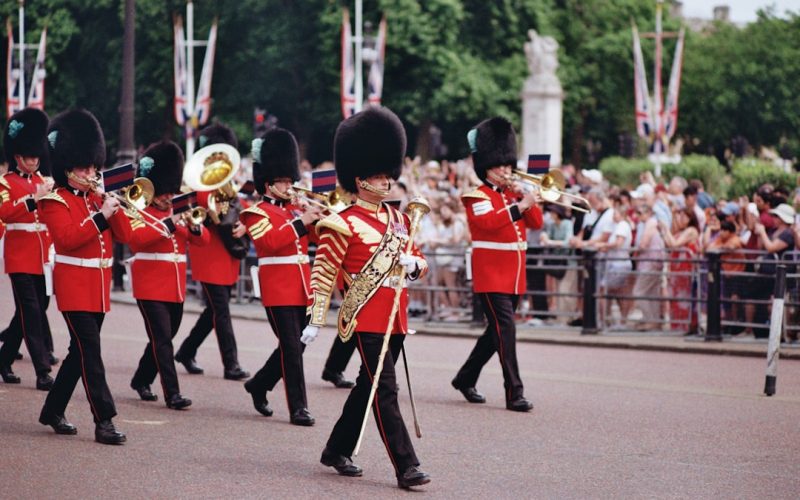 A british band is marching in a colorful parade.