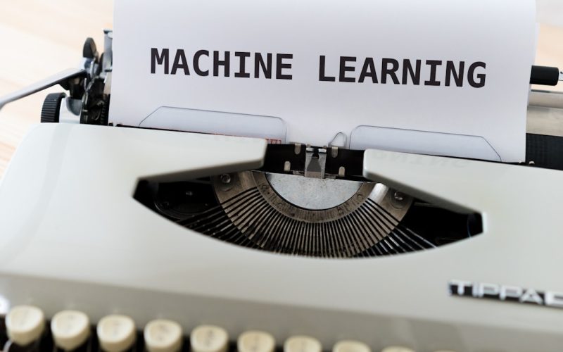 a close up of a typewriter with a paper reading machine learning