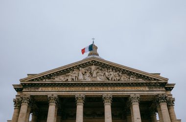 A tall building with a flag on top of it
