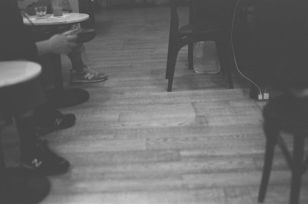 a black and white photo of a person sitting at a table