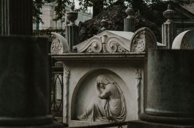 a statue of a woman with a veil in a cemetery